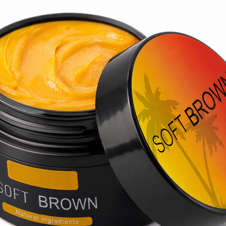 Macro view of Soft Brown 50 g tanning cream showing orange cream texture, black jar rim and orange-yellow lid detail clearly.