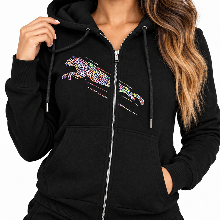 Close-up of black hooded top showing zipper, drawstrings, pocket stitching and multicolor chest graphic
