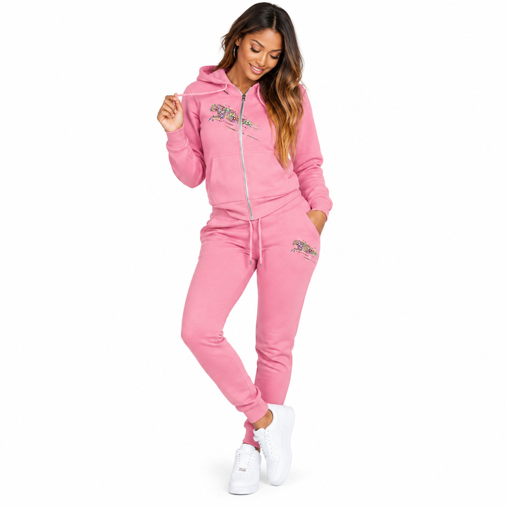 Pink hooded two piece tracksuit on a full-length model with zip top, pockets and drawstring joggers