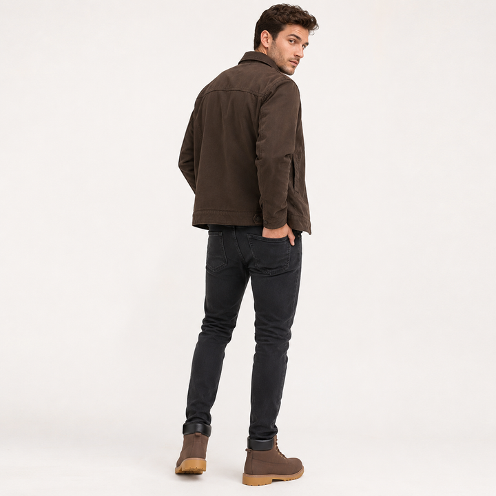 Male model wearing brown high-top casual boots with black padded collars and tan lug soles shown from the back