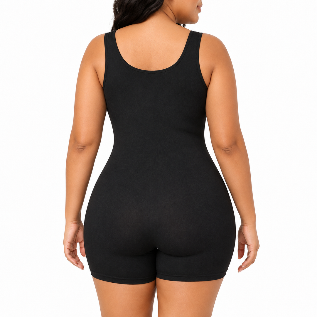 Black shapewear bodysuit back view on a model, showing wide straps, scoop back, a fitted shape and mid-thigh shorts on white.