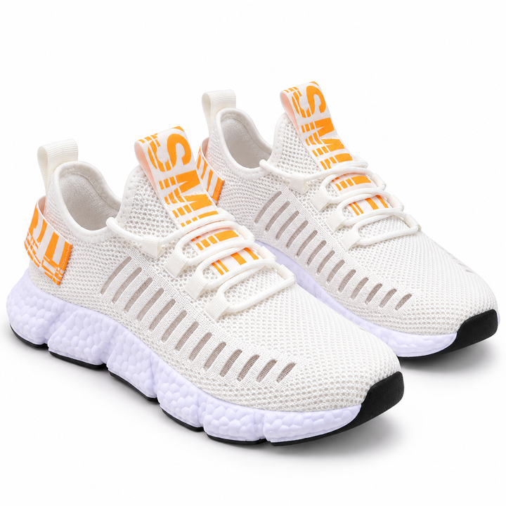 Casual sneakers in white with orange accents, mesh lining, round toe, cross-strap lacing and segmented white MD sole in view.