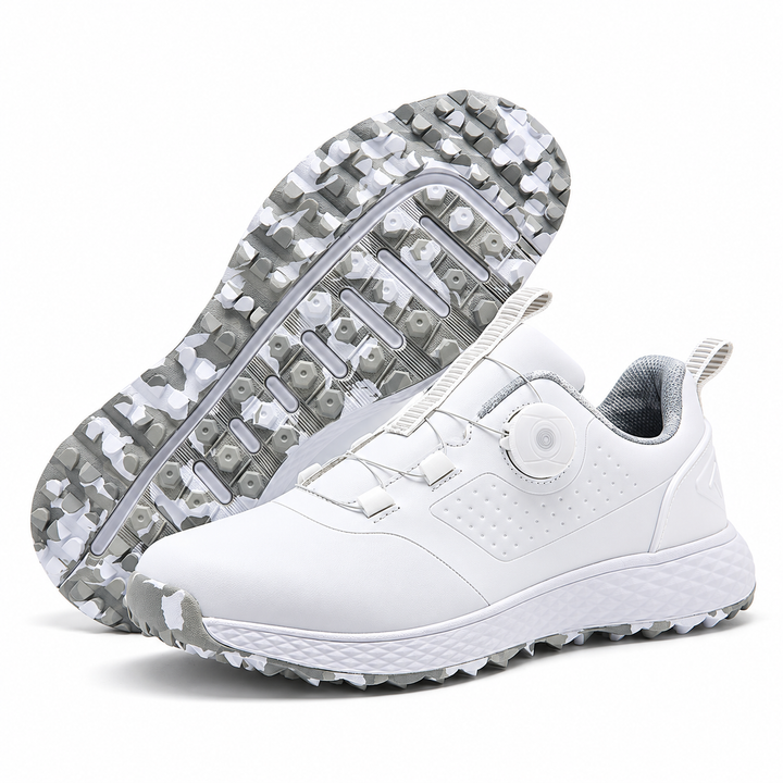 White &amp; gray golf shoes with rotary buckle closure, textured white midsole and patterned studded outsole on white background.