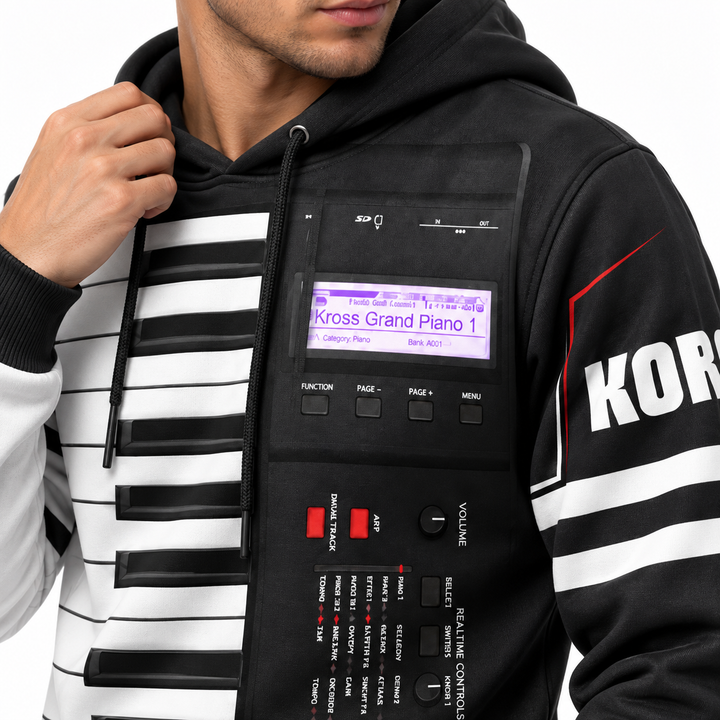 Close-up of the unisex keyboard print hoodie showing fabric texture, piano key print, synth panel graphic and seam details