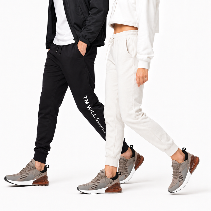 Man and woman wearing the brown Unisex Max Air running shoe variant in a studio walking pose on white.