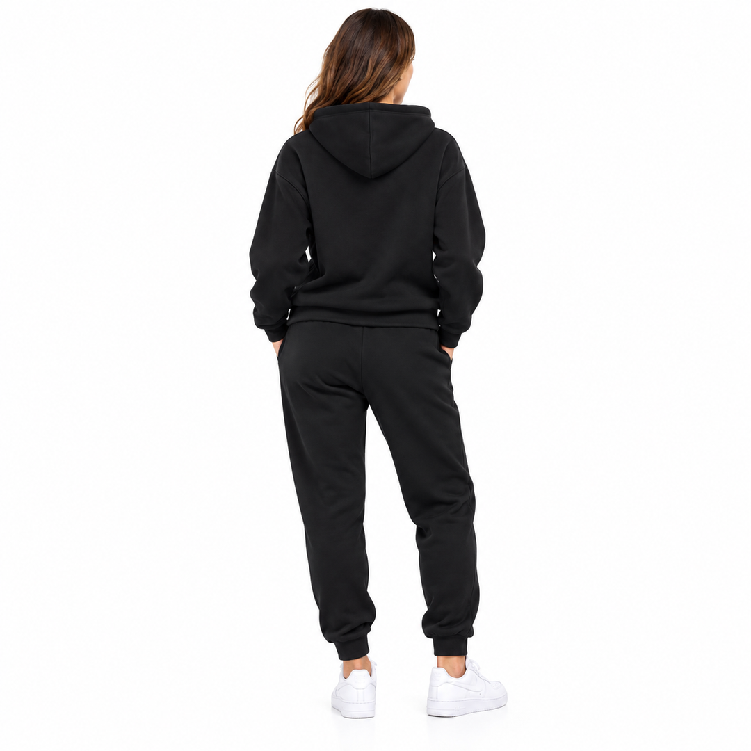 Unisex black New York hoodie and jogger set shown on a female model