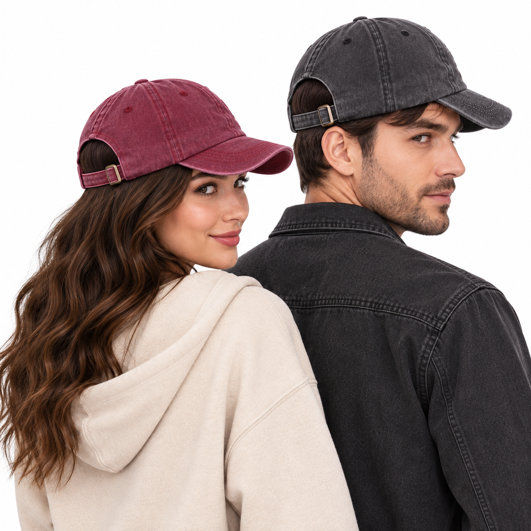 Woman and man wearing burgundy and charcoal adjustable NYC baseball caps from the back to show the rear strap and cap shape.