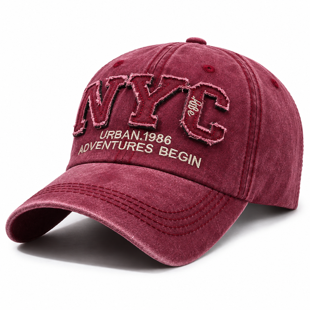 Burgundy adjustable NYC baseball cap shown alone on white with curved brim, washed finish and raised embroidered front detail.
