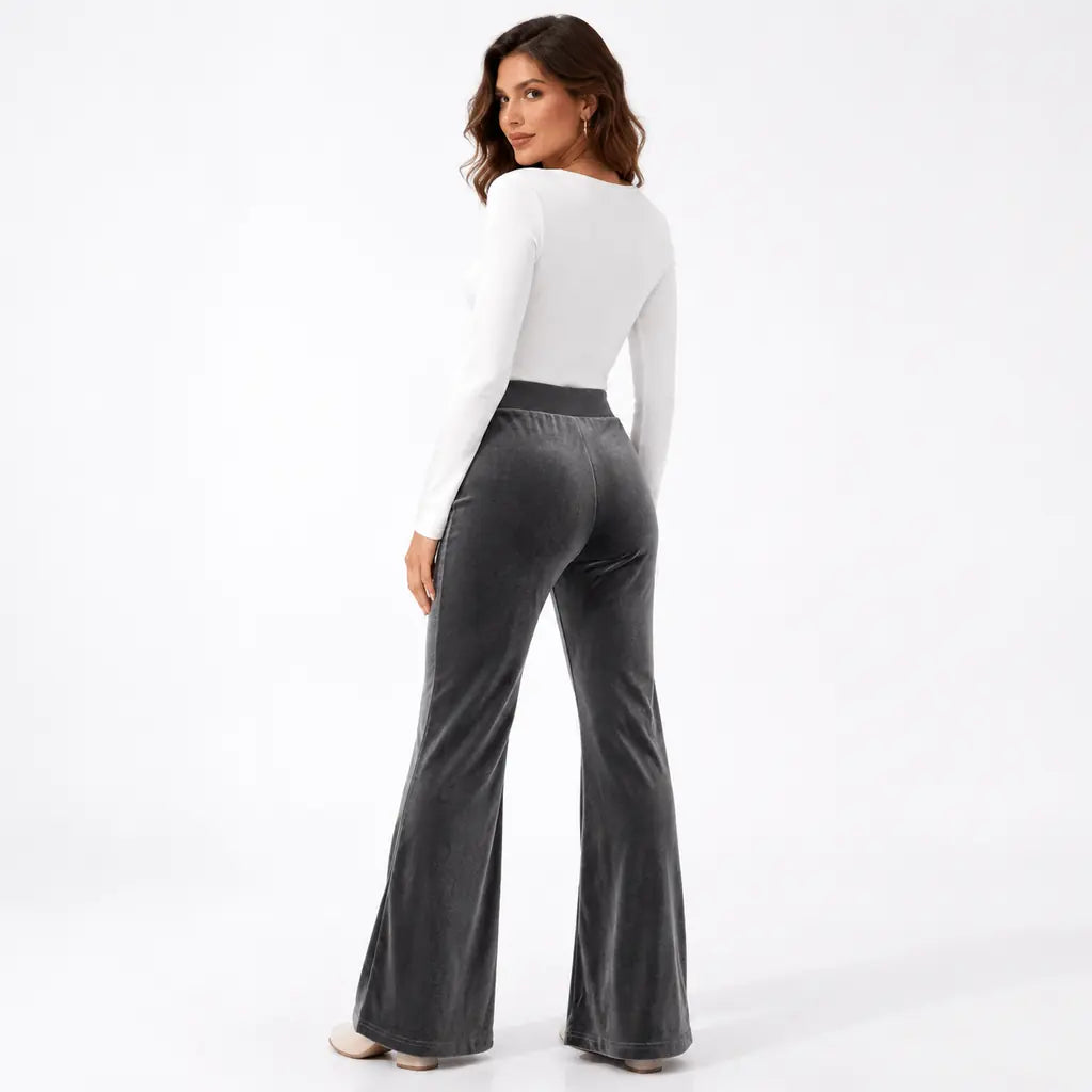 Dark gray velvet flare pants back view with face visible, plain rear styling, high waistband, rear seam and wide flared legs.
