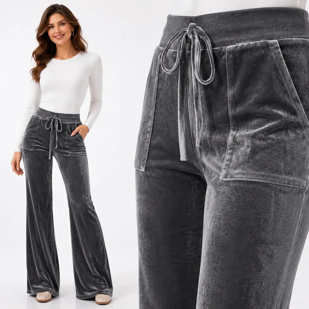 Dark gray velvet pants fabric detail with model, highlighting velvet nap, matching drawstring, pocket seams and clean finish.