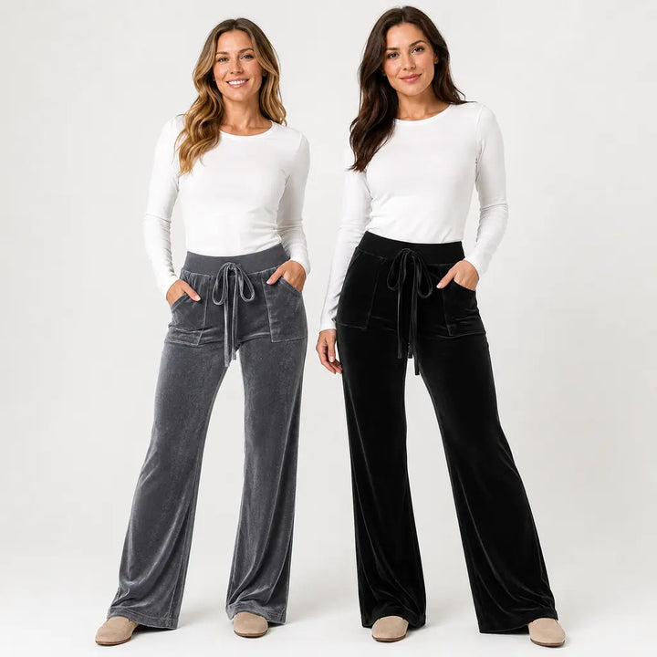 Dark gray and black velvet flare pants product hero with two models clear faces, drawstring waists and full wide flared legs.