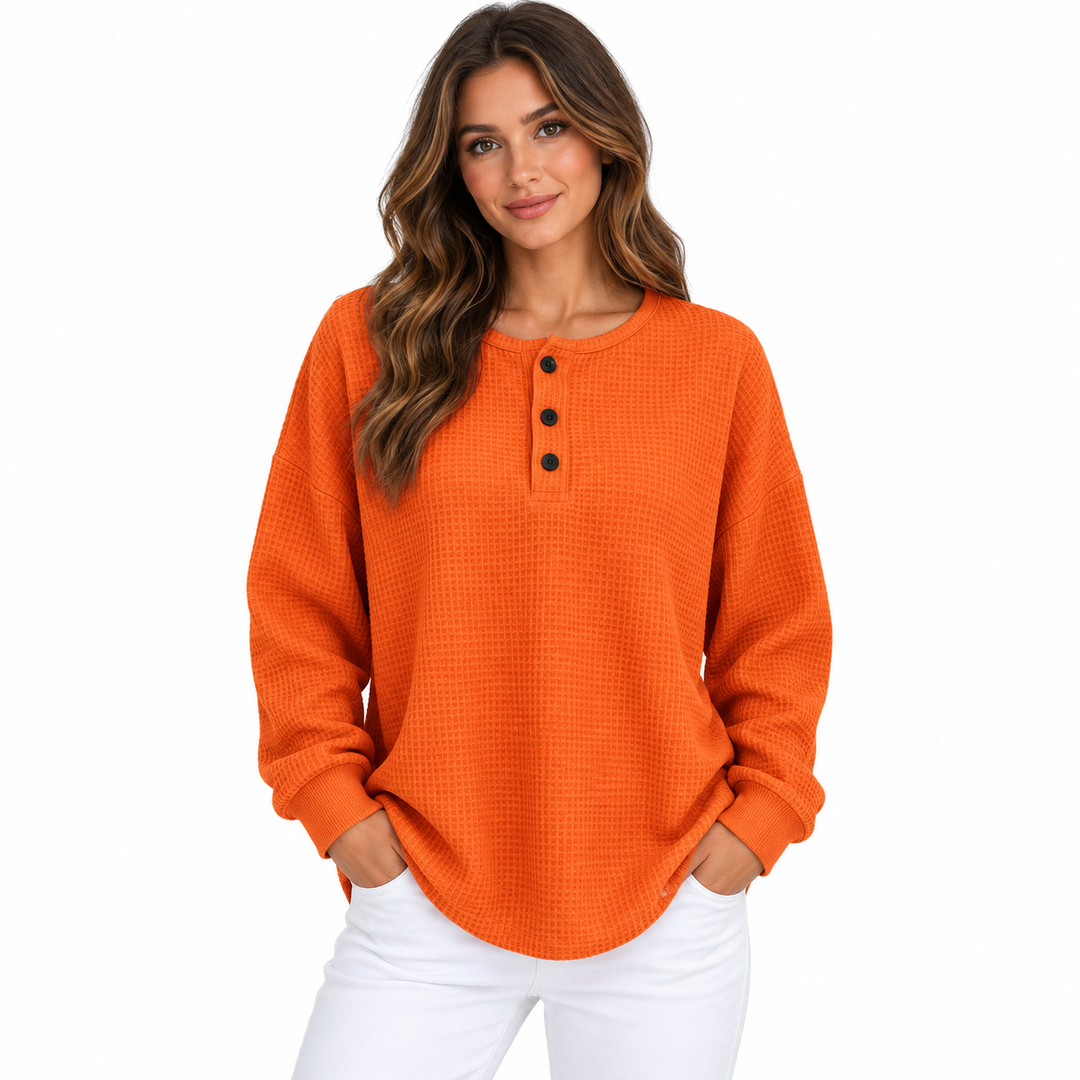 Waffle long sleeve shirt with buttons for women in orange, front model view showing loose fit, waffle texture and curved hem.