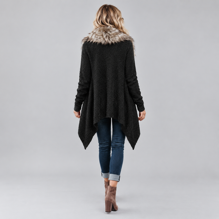 Back view of Black open-front cardigan on a female model showing long sleeves, plush collar and asymmetric pointed hem shape.