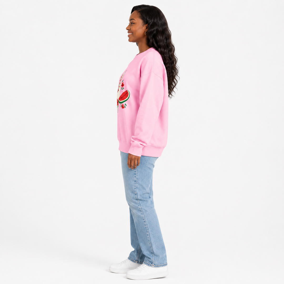 Pink watermelon sweatshirt for women shown in side view on a model to highlight the loose fit, long sleeves and graphic placement.