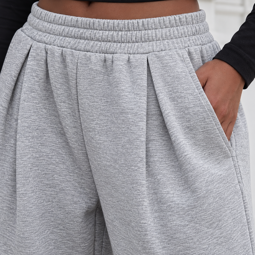 Close-up of the gray pants side pocket and elastic waistband