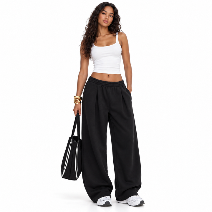 Black pants styled with a white top on a full-length model