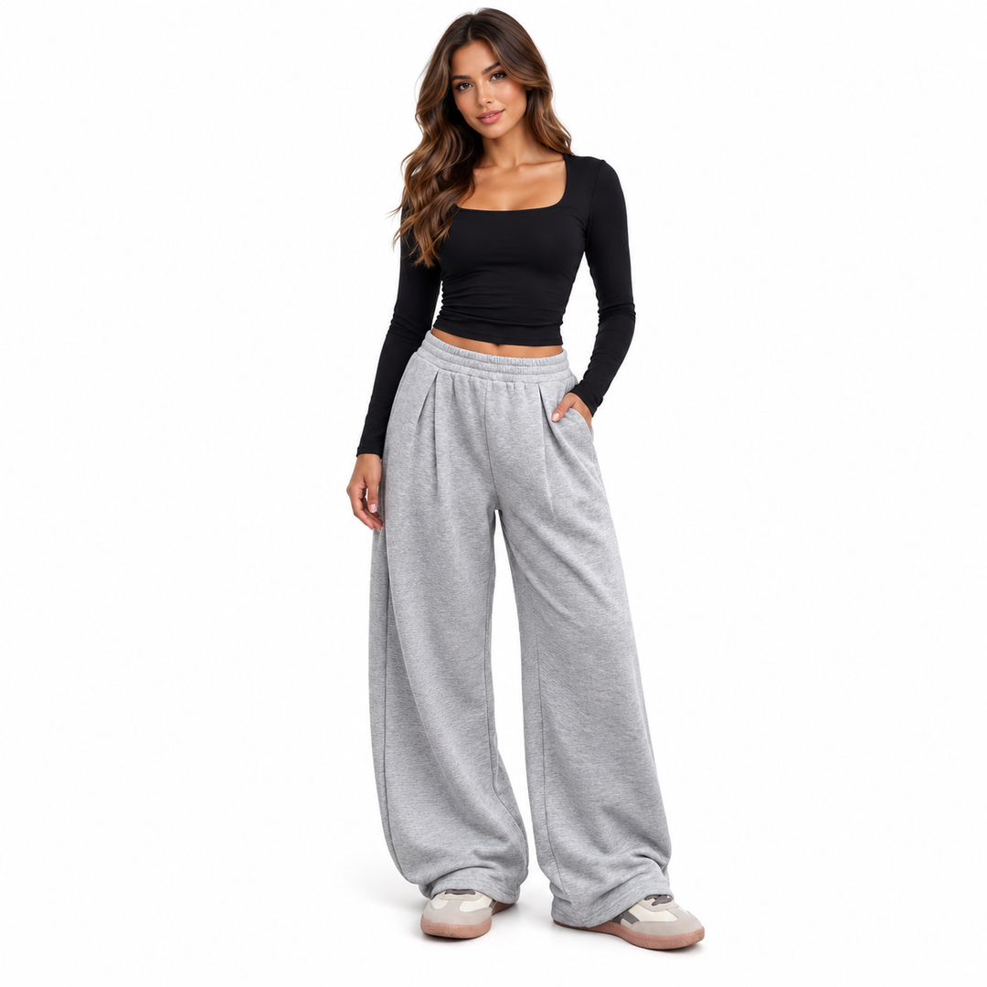 Gray wide leg sweatpants with elastic waist and pockets on a full-length model