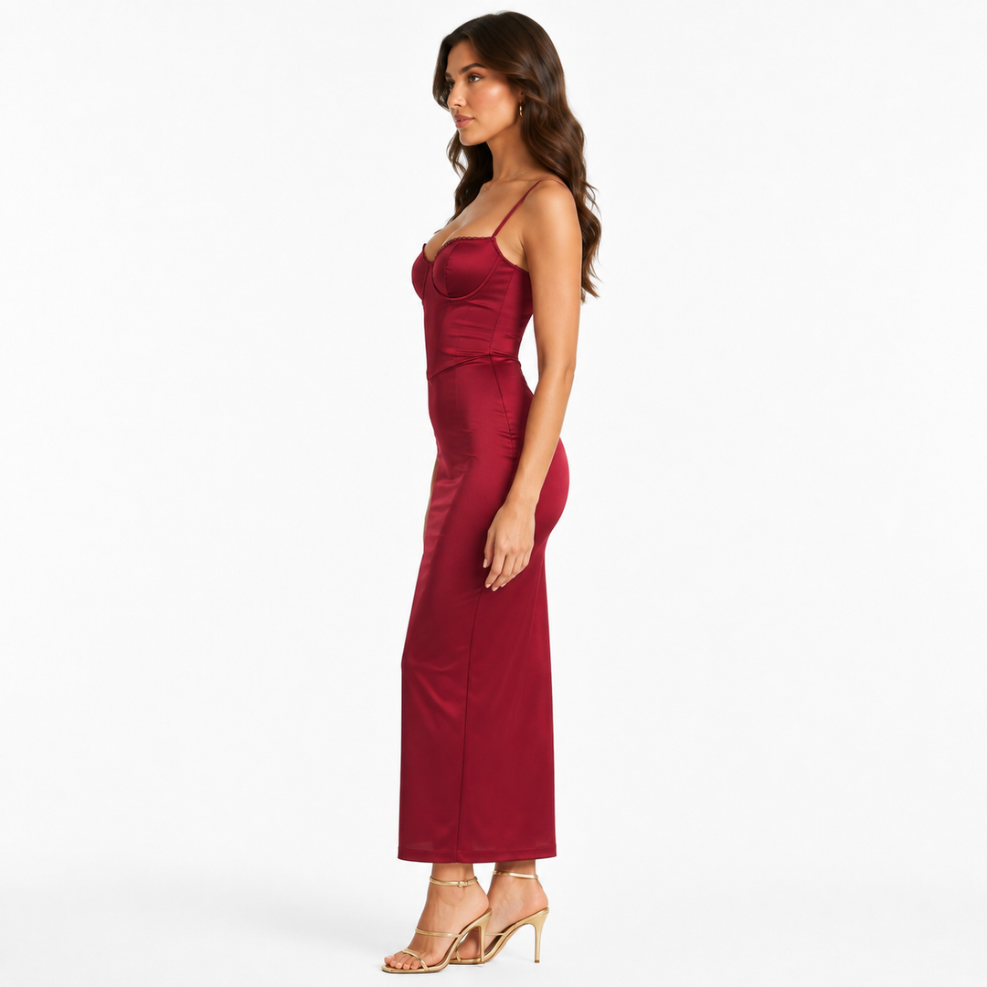 Wine red satin evening gown on woman in side profile, showing the fitted shape, thin straps and smooth satin finish