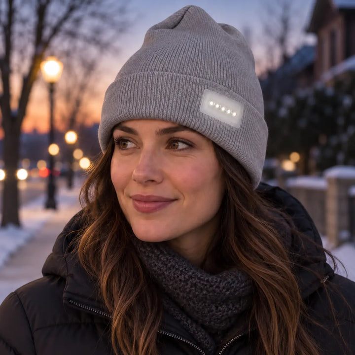 Winter knit cap worn by one woman during an evening stroll, showing the fitted shape and illuminated five-light front module.