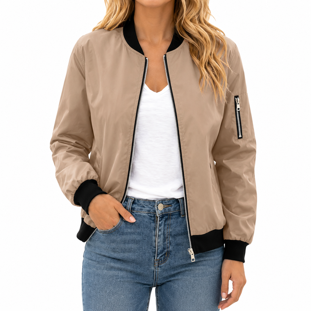 Khaki bomber jacket front view on the model with black ribbed collar, cuffs and hem plus silver front and sleeve zip details.
