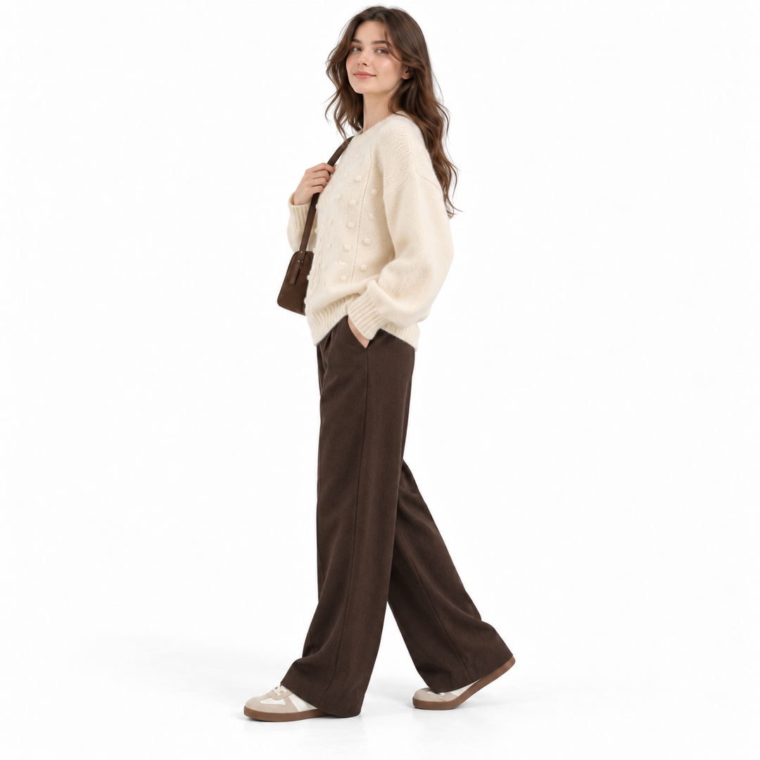 Ivory cable knit sweater side view with loose silhouette and long sleeves