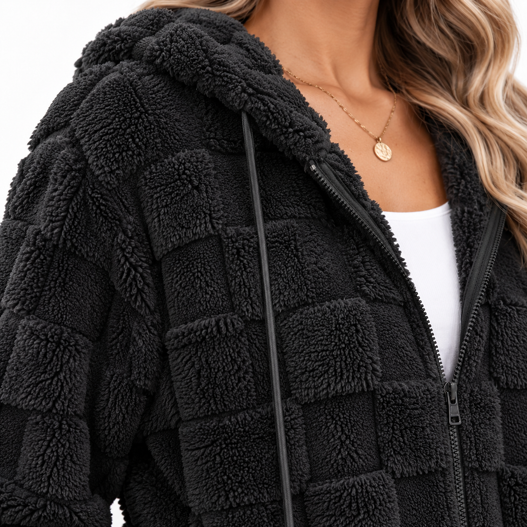 Close-up of the Black plush hooded cardigan jacket showing the textured block surface, hood edge, zipper and drawstring detail