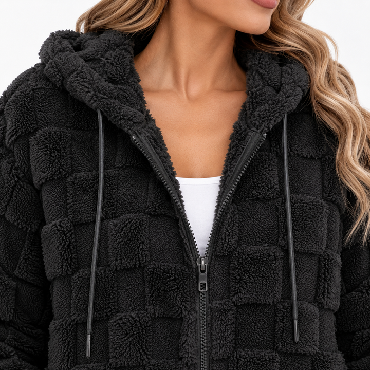 Close-up of the Black plush hooded zip-up cardigan jacket showing the zipper, hood opening, drawstrings and textured surface