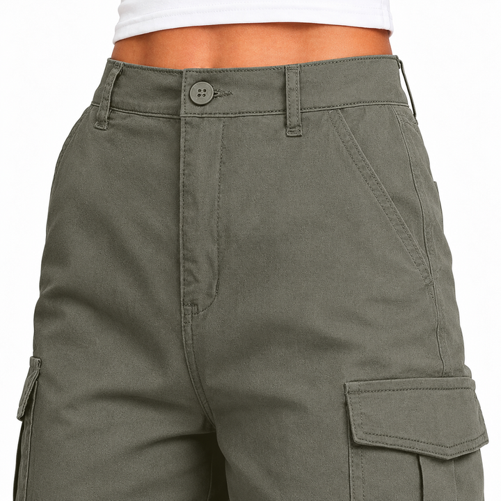 Close-up of army green multi-pocket shorts showing the waistband, button closure, stitching and visible cargo pocket details.