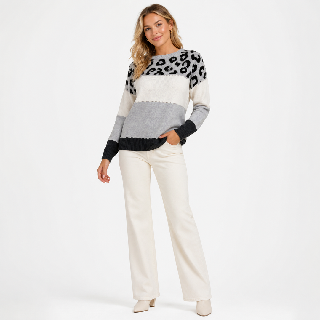 Women's color-block leopard sweater shown full length on a model in a clean studio product view.