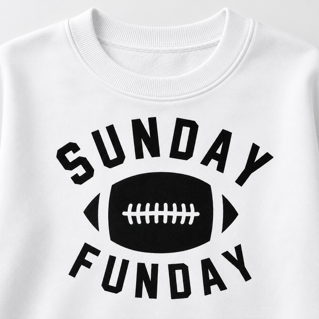Close-up of white football graphic sweatshirt shows ribbed crew neckline and black Sunday Funday chest print details in view.