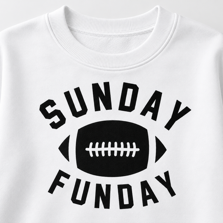 Close-up of white football graphic sweatshirt shows ribbed crew neckline and black Sunday Funday chest print details in view.