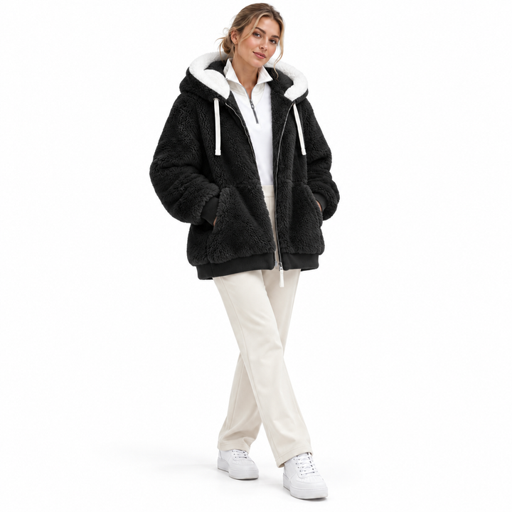Black hooded jacket on model with front zipper, white hood lining and pockets