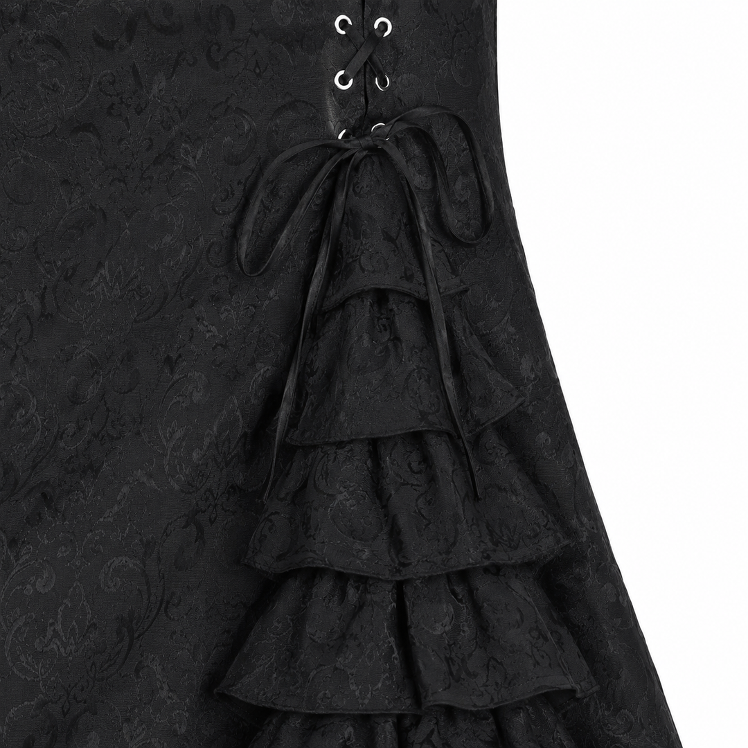 Close-up of the black fishtail long skirt surface, seams and layered ruffle construction