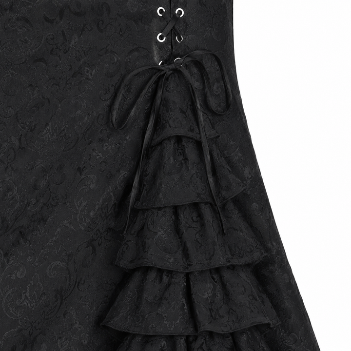 Close-up of the black fishtail long skirt surface, seams and layered ruffle construction