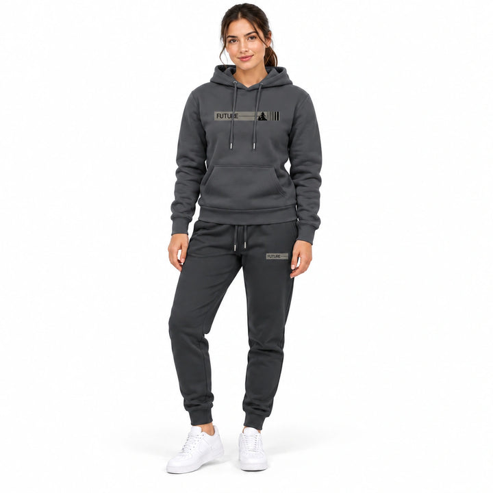 Woman wearing the dark charcoal-gray hoodie and matching pants set on a white background