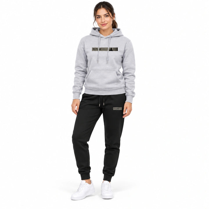 Woman wearing the light gray graphic hoodie and black matching pants set