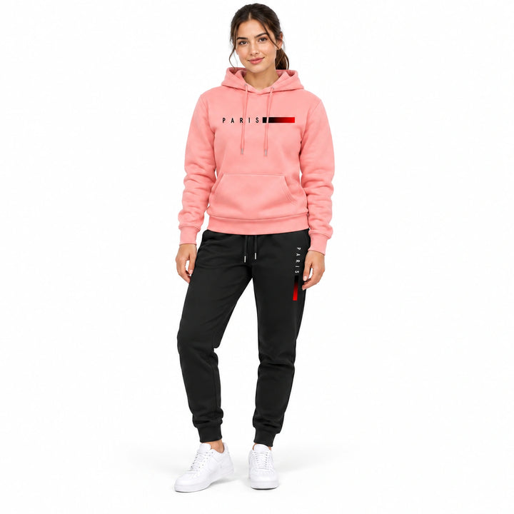 Woman wearing the salmon pink hoodie and black pants set on a white background