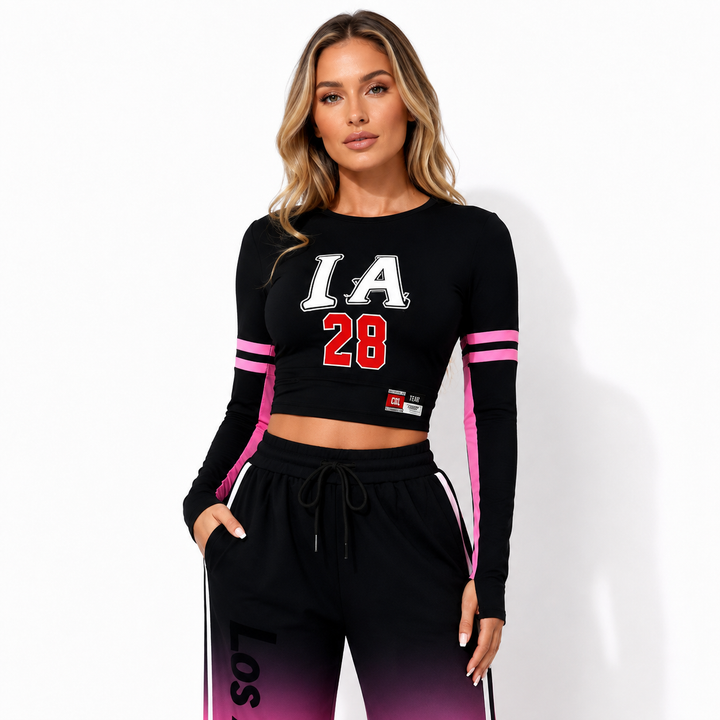 Close detail view of the black-to-pink gradient two piece set highlighting the cropped top, wide-leg pants, and print details