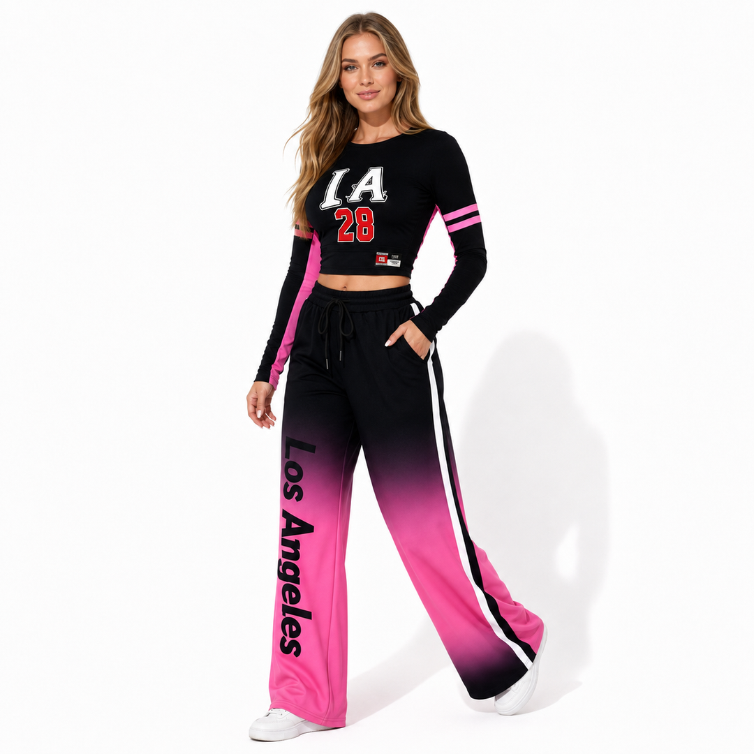 Black-to-pink gradient two piece outfit in a walking pose, with cropped top, wide-leg pants, and coordinated streetwear style