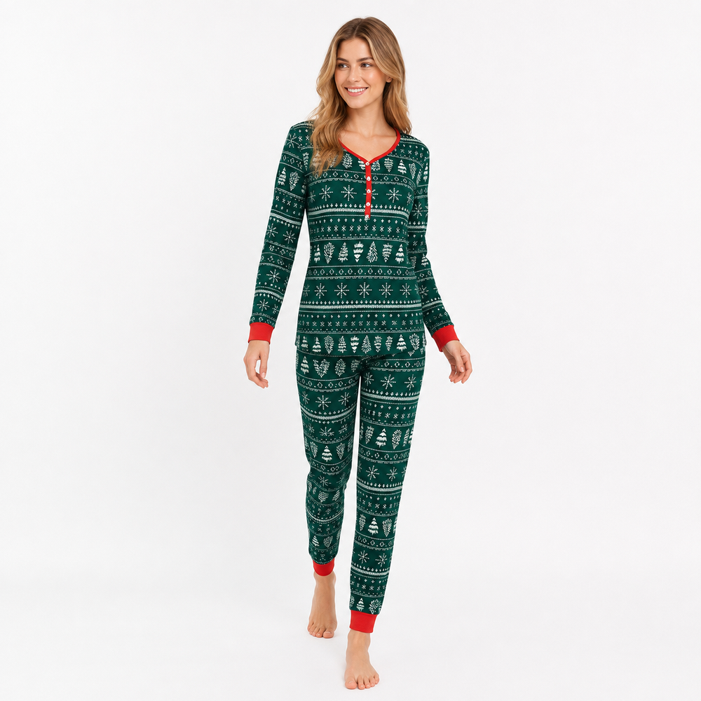 Woman modeling green matching Christmas pajamas in a natural walking pose on a white studio background.