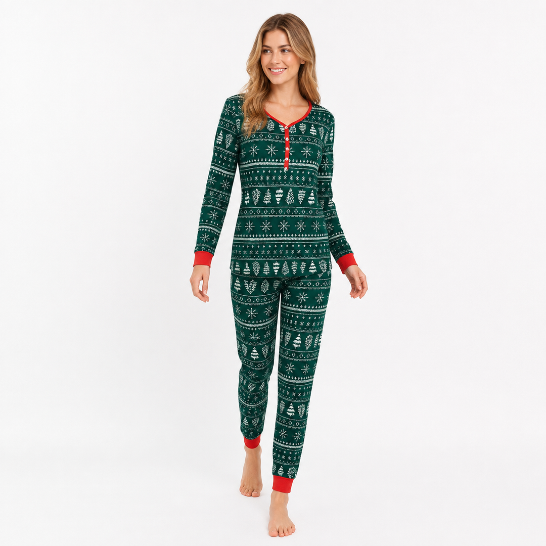 Woman modeling green matching Christmas pajamas in a natural walking pose on a white studio background.