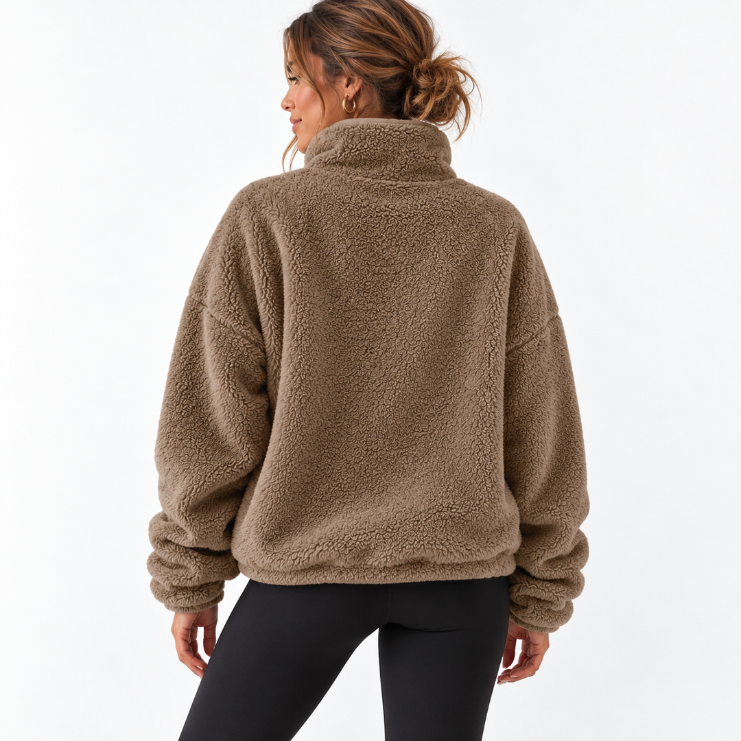 Caramel fleece half zip sweater shown from the back on a model, highlighting the stand collar, long sleeves and clean silhouette.