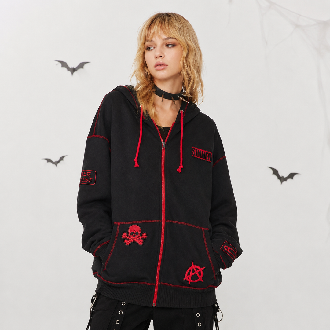 Women's Halloween zip-up hoodie with black fabric, red trim and gothic patch details on model