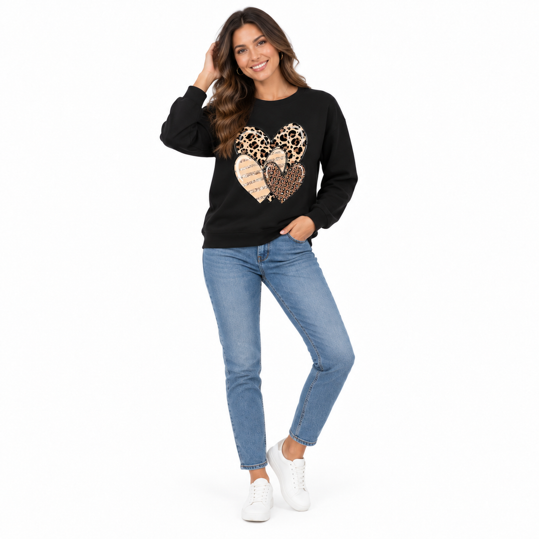 Black long sleeve heart print top on a full-body model with jeans for casual everyday styling.