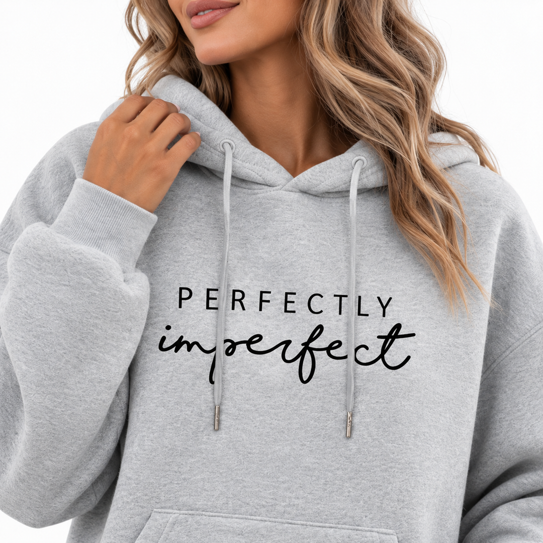 Grey hoodie close-up showing Perfectly Imperfect chest print and drawstring hood details