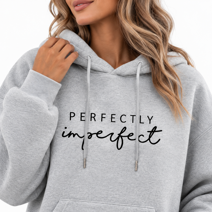 Grey hoodie close-up showing Perfectly Imperfect chest print and drawstring hood details