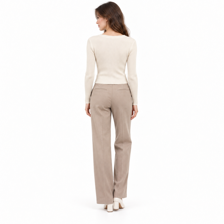Oatmeal ribbed knit top back view showing the fitted long sleeves and clean pullover silhouette.