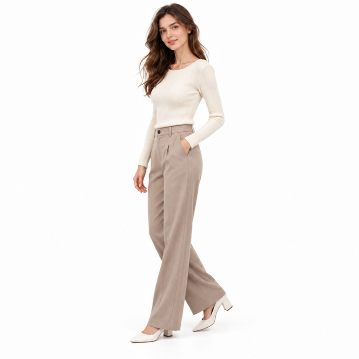 Oatmeal knit pullover three-quarter view styled with tailored neutral trousers on a white studio background.