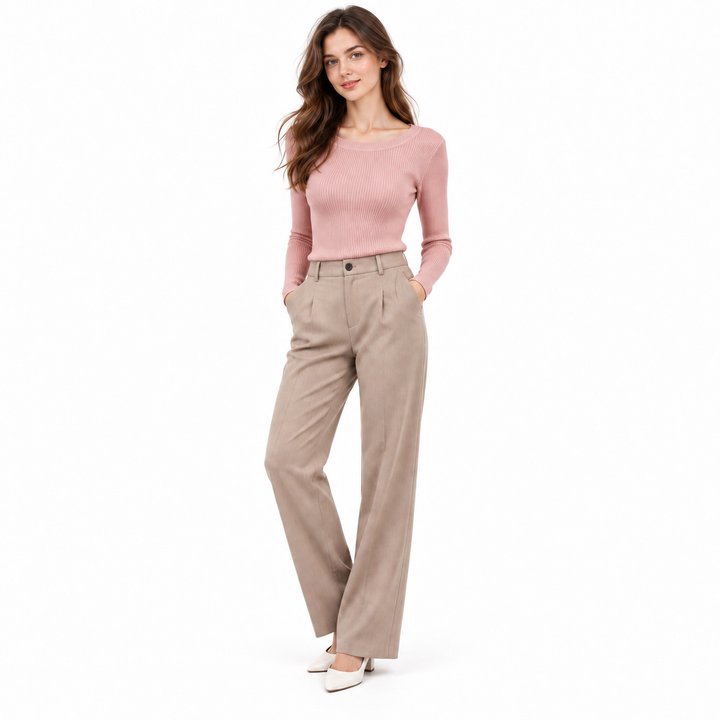 Pink ribbed knit pullover on a full-body model with neutral tailored trousers for an everyday layered look.