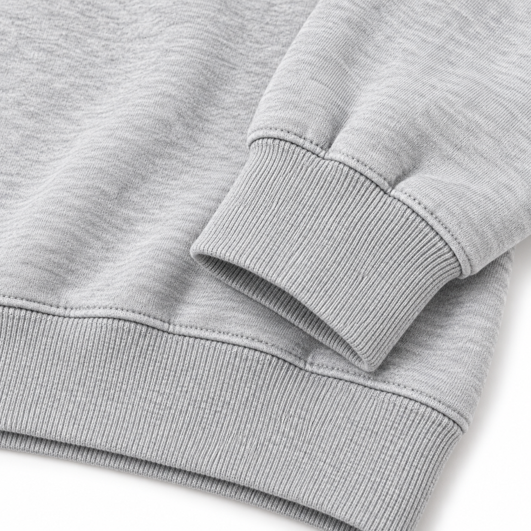 Close-up of heather gray sweatshirt ribbed cuff and hem stitching